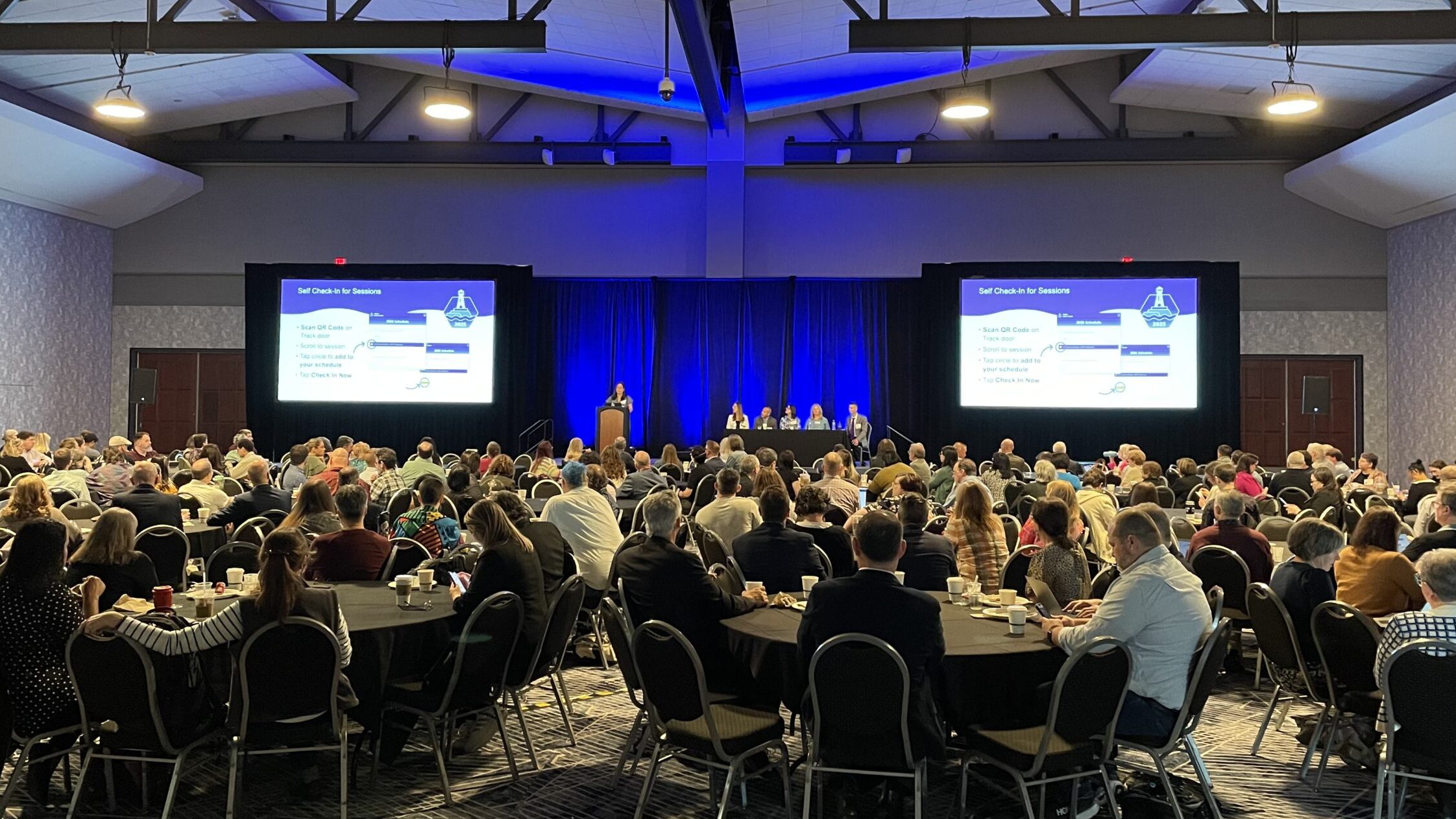 Crowd seated in a ballroom listening to the EUG2025 Opening Session