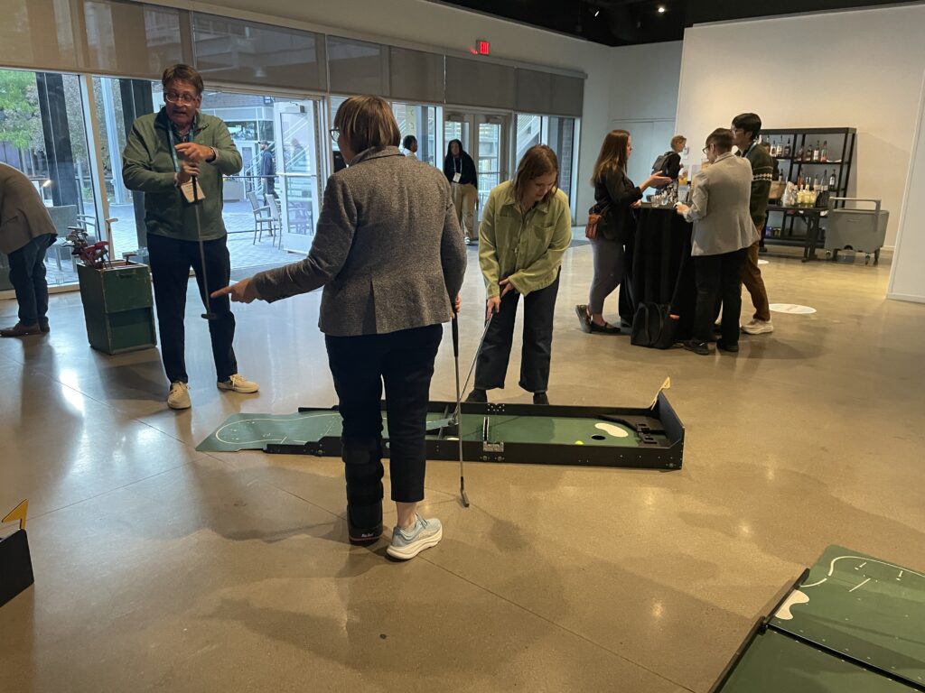 Playing mini golf at the Reception event