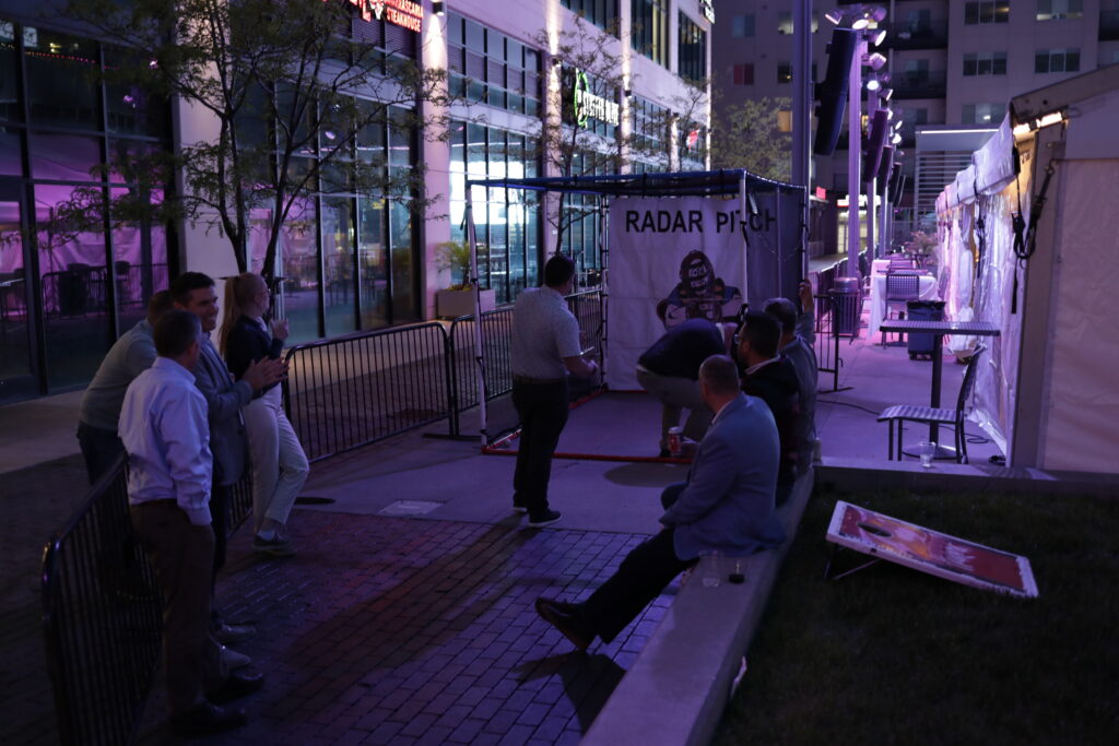 Throwing our fastest pitches with the radar pitch machine at the Reception event